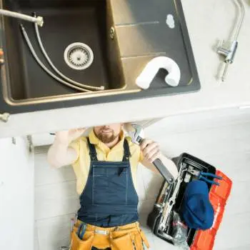 plumber cleaning drain