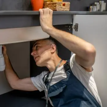 plumber fixing sink