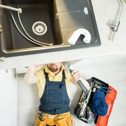 plumber cleaning drain