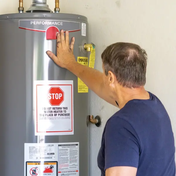 plumber inspecting hot water tank